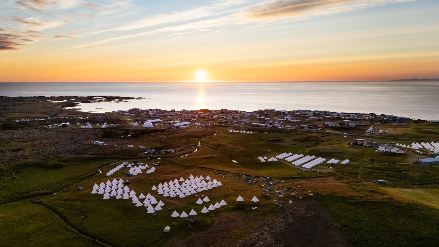 Aerial view of the Iceland Eclipse tented village at golden hour